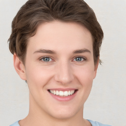 Joyful white young-adult female with short  brown hair and grey eyes