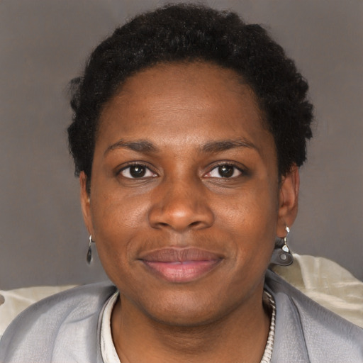 Joyful black young-adult female with short  black hair and brown eyes