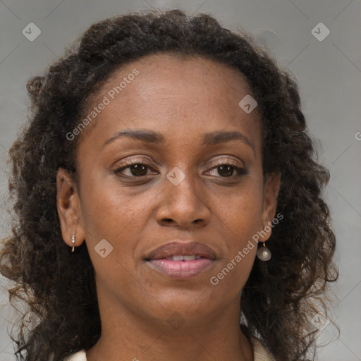 Joyful black adult female with medium  brown hair and brown eyes