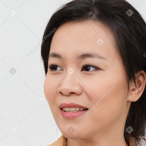 Joyful asian young-adult female with medium  brown hair and brown eyes