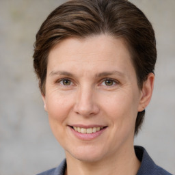 Joyful white adult female with medium  brown hair and grey eyes