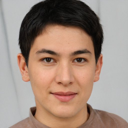 Joyful asian young-adult male with short  brown hair and brown eyes