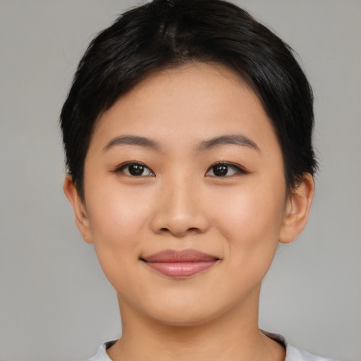 Joyful asian young-adult female with short  black hair and brown eyes