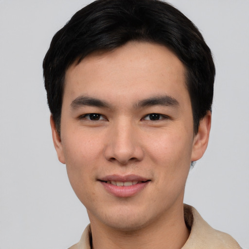 Joyful asian young-adult male with short  black hair and brown eyes