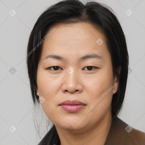 Joyful asian adult female with medium  brown hair and brown eyes