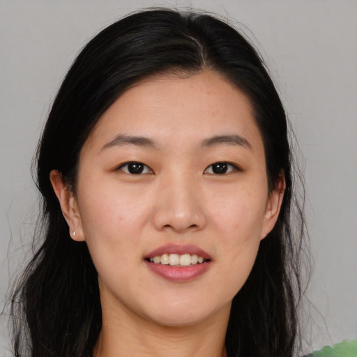 Joyful asian young-adult female with long  black hair and brown eyes