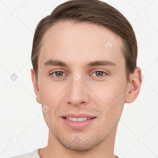 Joyful white young-adult male with short  brown hair and grey eyes