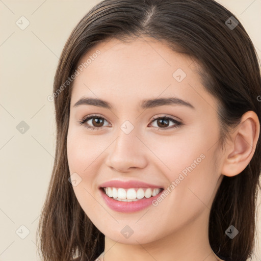 Joyful white young-adult female with long  brown hair and brown eyes