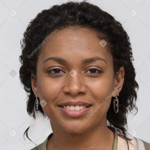 Joyful black young-adult female with long  brown hair and brown eyes