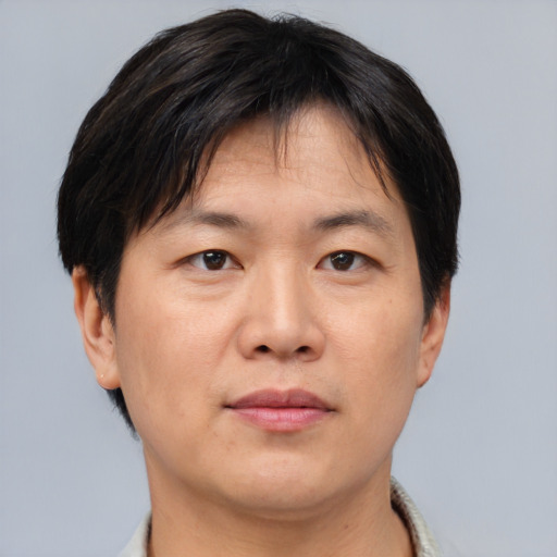 Neutral asian adult male with short  brown hair and brown eyes