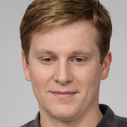 Joyful white adult male with short  brown hair and grey eyes