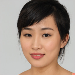 Joyful asian young-adult female with medium  black hair and brown eyes