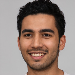 Joyful latino young-adult male with short  black hair and brown eyes