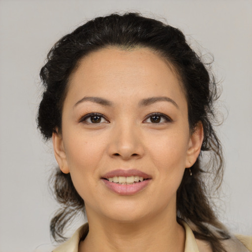 Joyful latino young-adult female with medium  brown hair and brown eyes