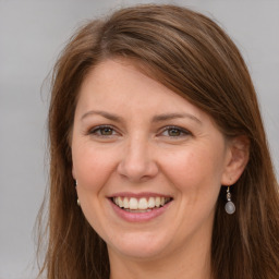 Joyful white young-adult female with long  brown hair and grey eyes