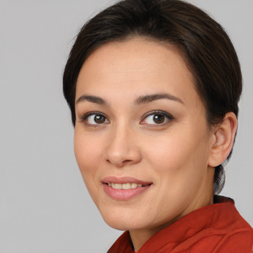 Joyful white young-adult female with medium  brown hair and brown eyes