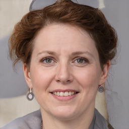 Joyful white adult female with medium  brown hair and grey eyes