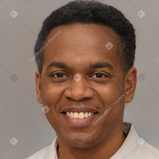 Joyful black young-adult male with short  black hair and brown eyes