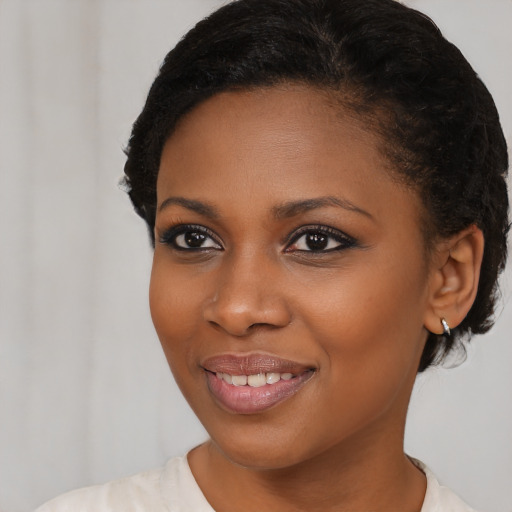 Joyful black young-adult female with short  brown hair and brown eyes