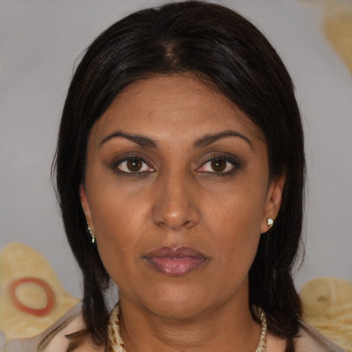 Joyful asian adult female with medium  brown hair and brown eyes