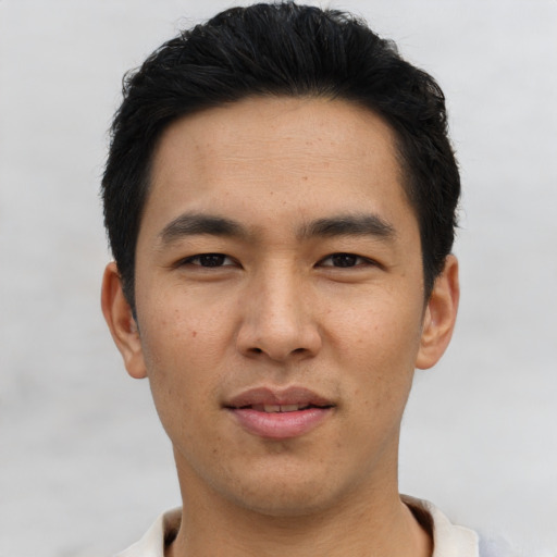 Joyful asian young-adult male with short  black hair and brown eyes