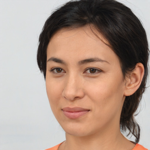 Joyful asian young-adult female with medium  brown hair and brown eyes