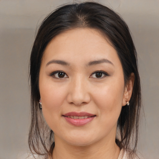 Joyful asian young-adult female with medium  brown hair and brown eyes