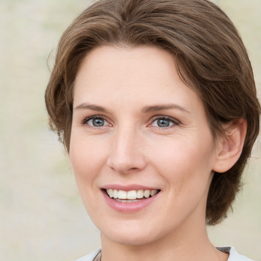 Joyful white young-adult female with medium  brown hair and green eyes