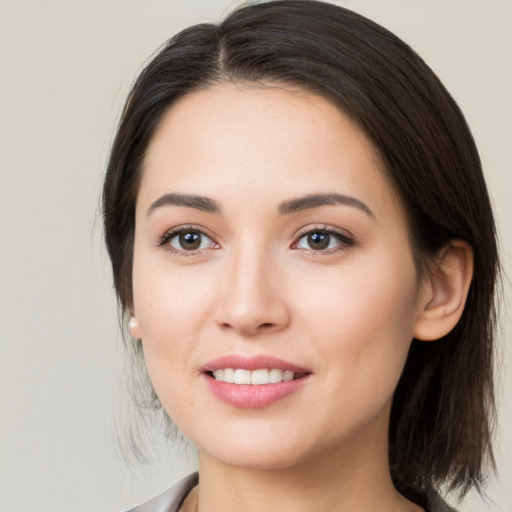 Joyful white young-adult female with medium  brown hair and brown eyes