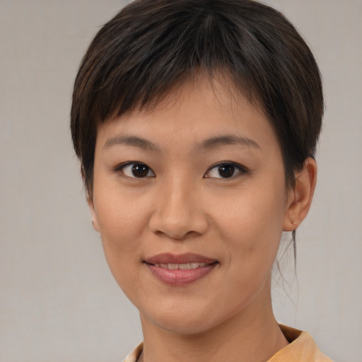 Joyful asian young-adult female with medium  brown hair and brown eyes