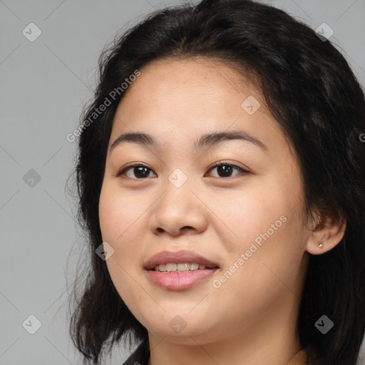 Joyful asian young-adult female with long  brown hair and brown eyes