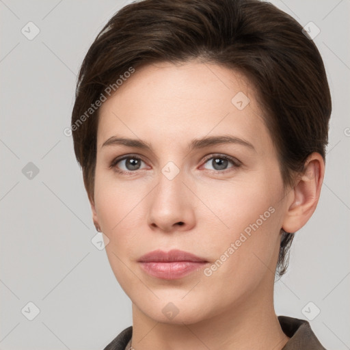 Joyful white young-adult female with short  brown hair and grey eyes