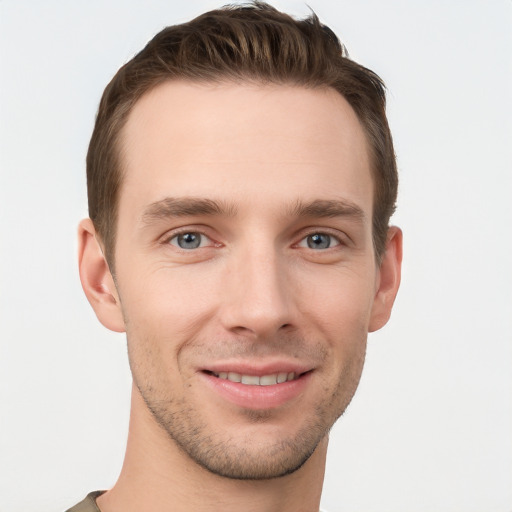 Joyful white young-adult male with short  brown hair and grey eyes