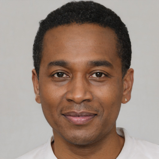 Joyful latino adult male with short  black hair and brown eyes