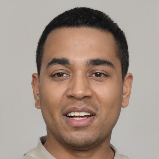 Joyful latino young-adult male with short  black hair and brown eyes