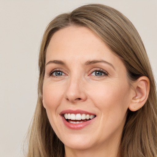 Joyful white young-adult female with long  brown hair and grey eyes