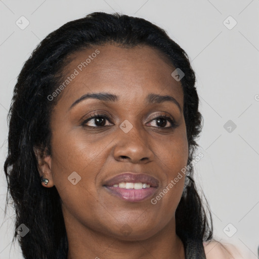 Joyful black young-adult female with long  brown hair and brown eyes