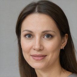 Joyful white adult female with long  brown hair and brown eyes