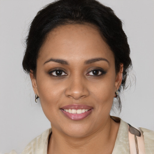 Joyful black young-adult female with medium  brown hair and brown eyes