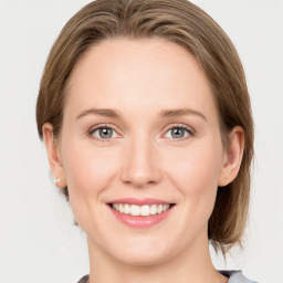 Joyful white young-adult female with medium  brown hair and blue eyes