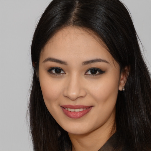 Joyful latino young-adult female with long  brown hair and brown eyes