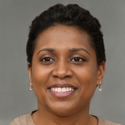 Joyful black young-adult female with short  brown hair and brown eyes