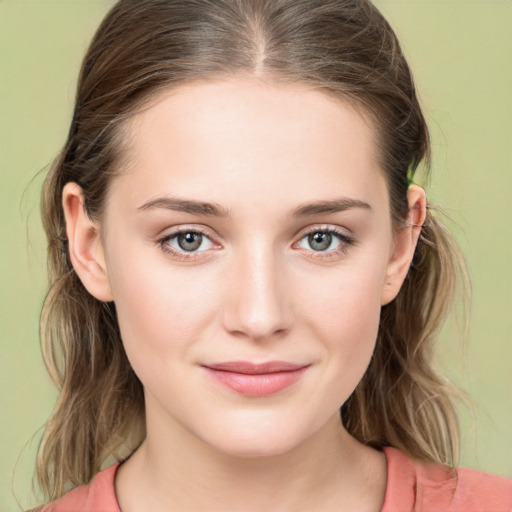 Joyful white young-adult female with medium  brown hair and green eyes