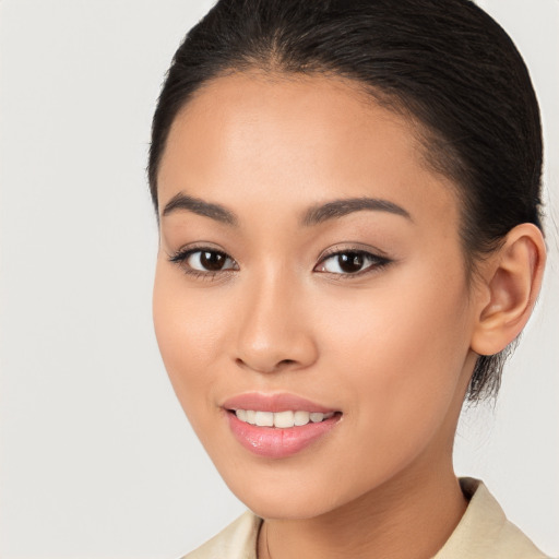 Joyful latino young-adult female with medium  brown hair and brown eyes