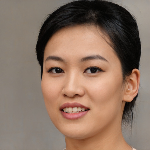 Joyful asian young-adult female with medium  brown hair and brown eyes