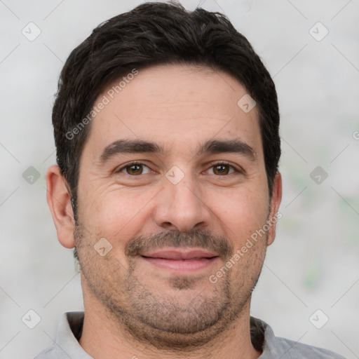 Joyful white adult male with short  black hair and brown eyes