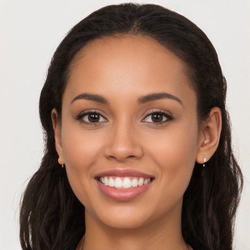 Joyful latino young-adult female with long  brown hair and brown eyes