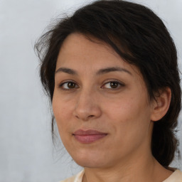 Joyful white adult female with medium  brown hair and brown eyes