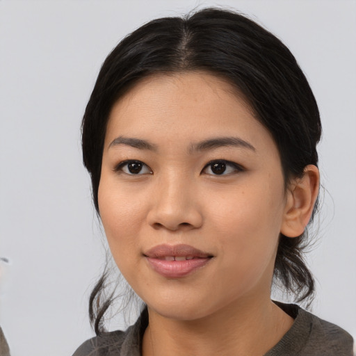 Joyful asian young-adult female with medium  black hair and brown eyes