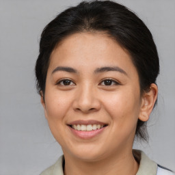 Joyful asian young-adult female with medium  brown hair and brown eyes